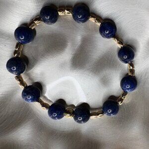 bracelet features polished deep navy-blue gemstone beads
